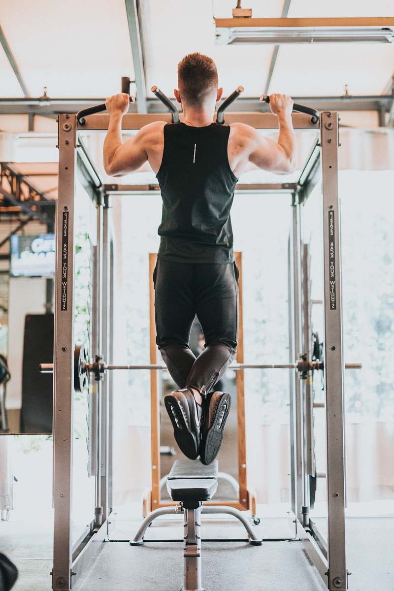 person man doing pull-ups footwear