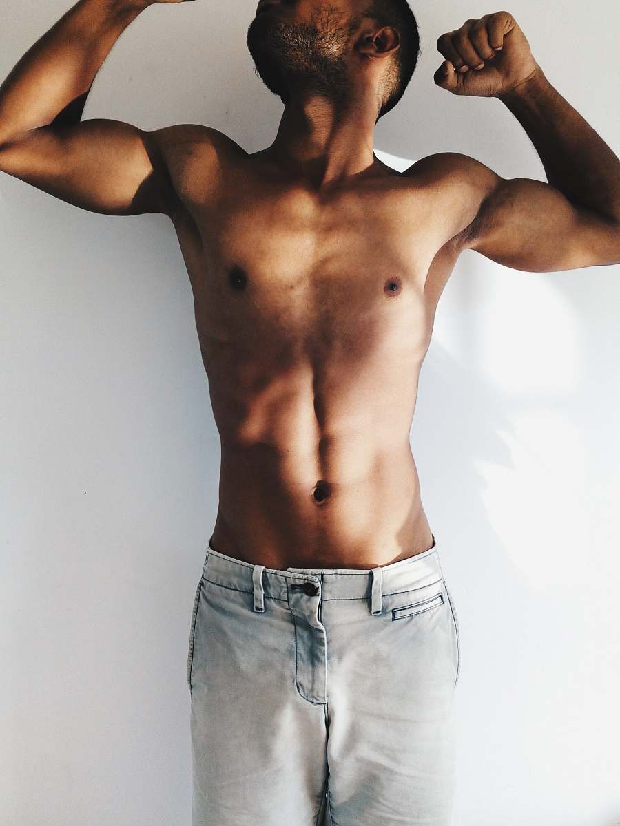 person man in blue denim bottoms flexing people