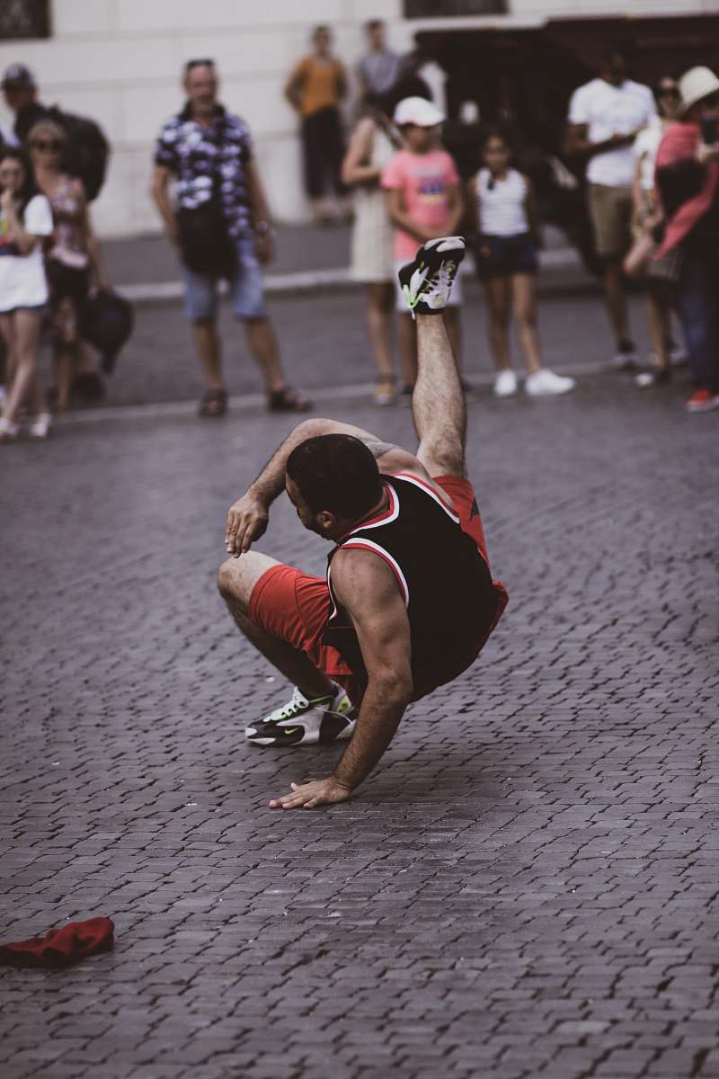 person man in red and black break dancing pedestrian