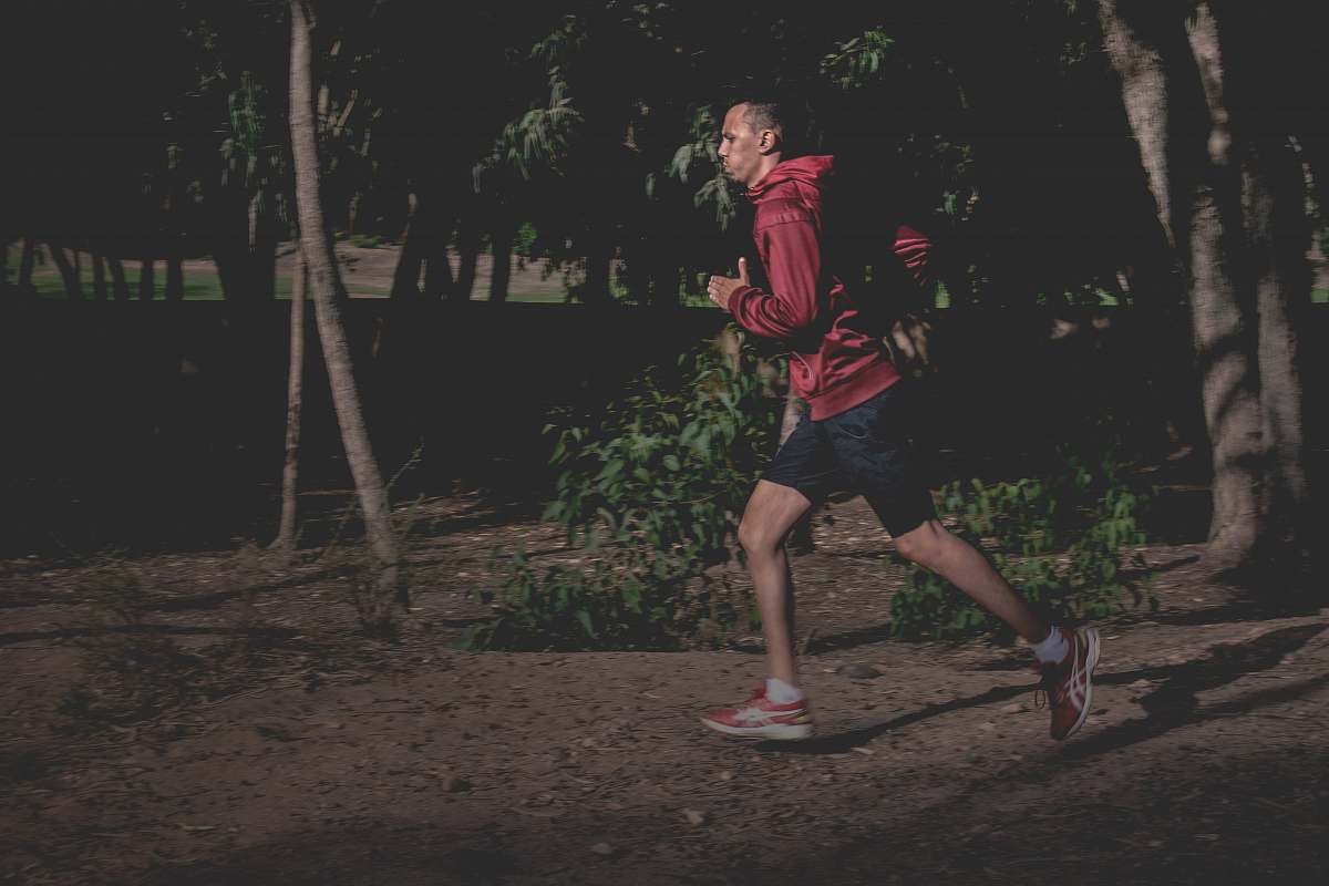 person man in red hoodie running people