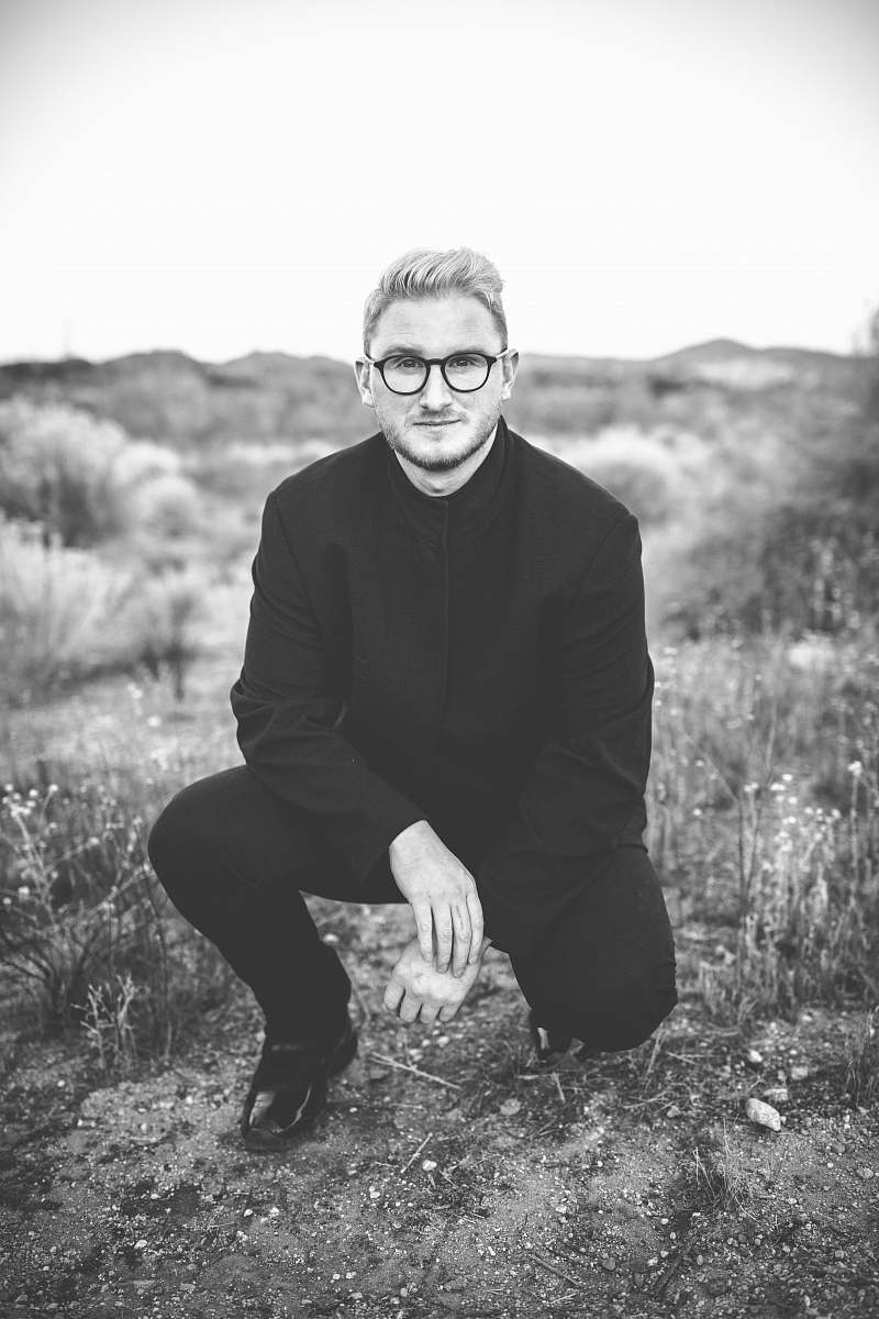 person man in suit kneeling black-and-white