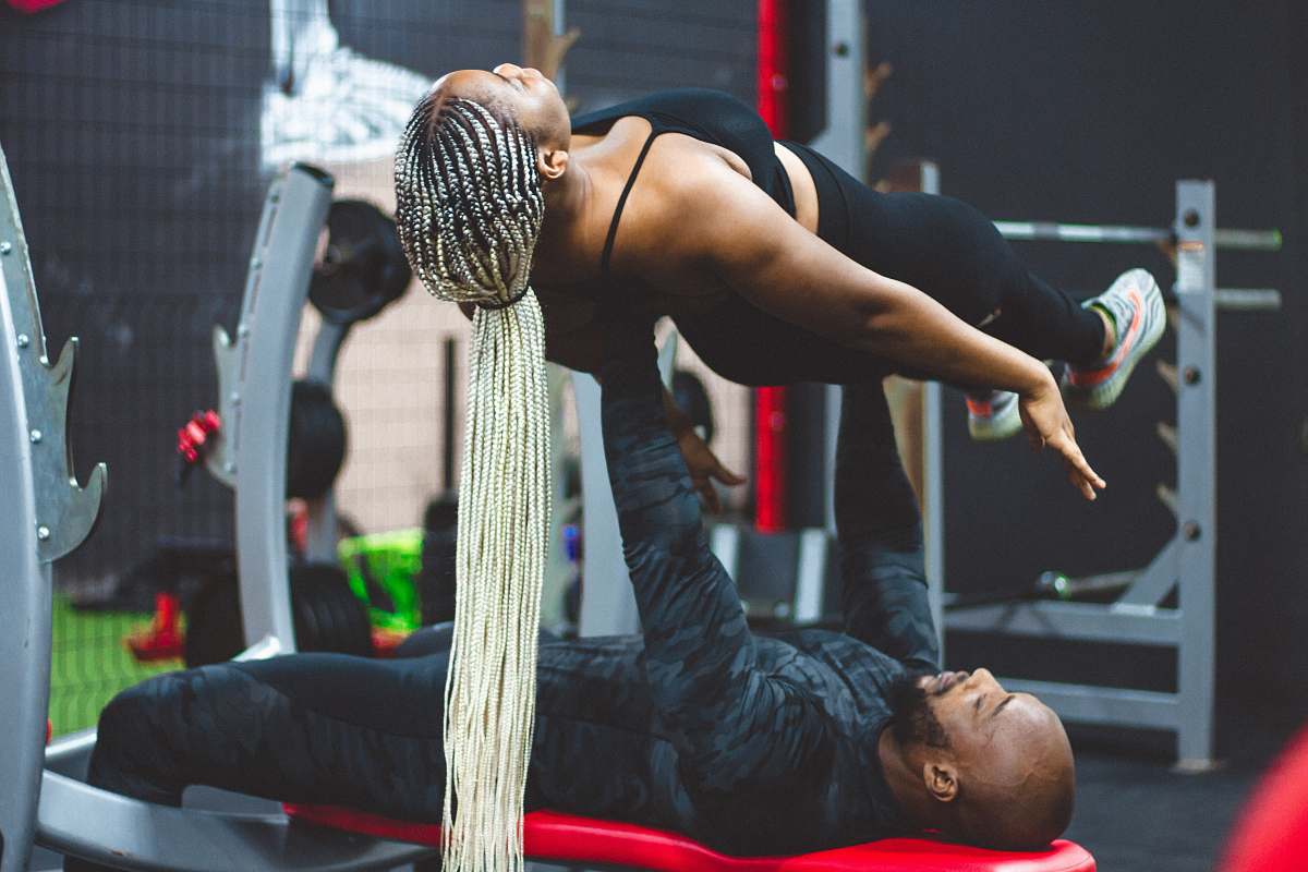 person man lifting woman working out