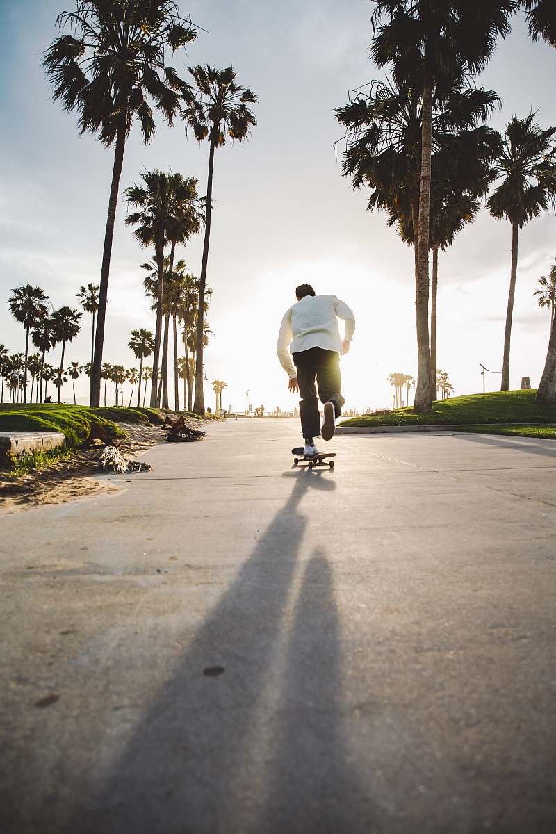 person man riding on skateboard on road skateboard