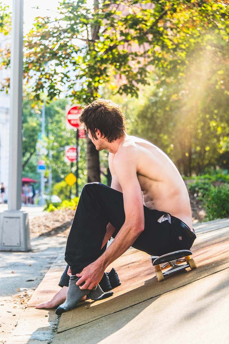 person man sitting on skateboard apparel