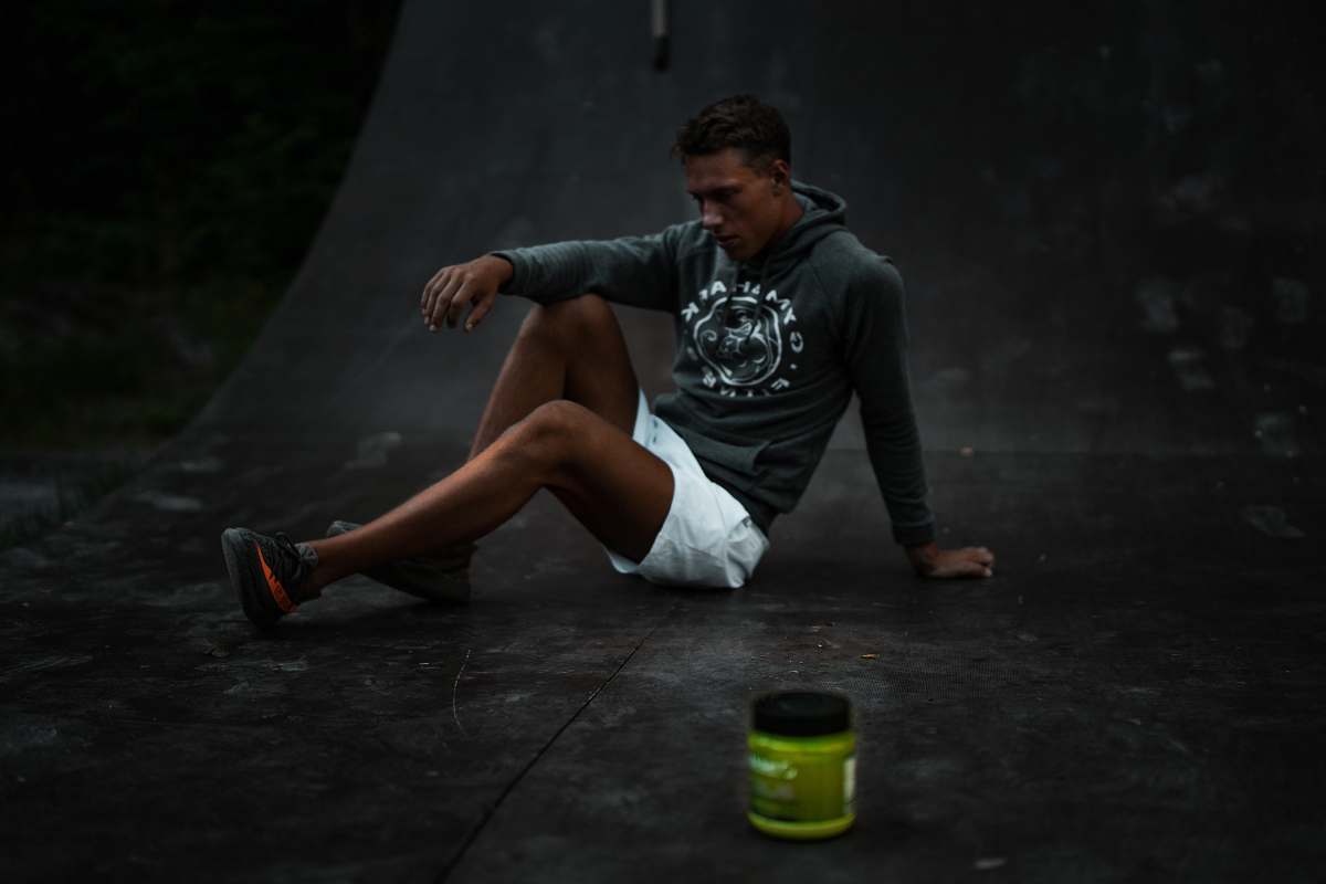 person man sitting on skateboard tracks people