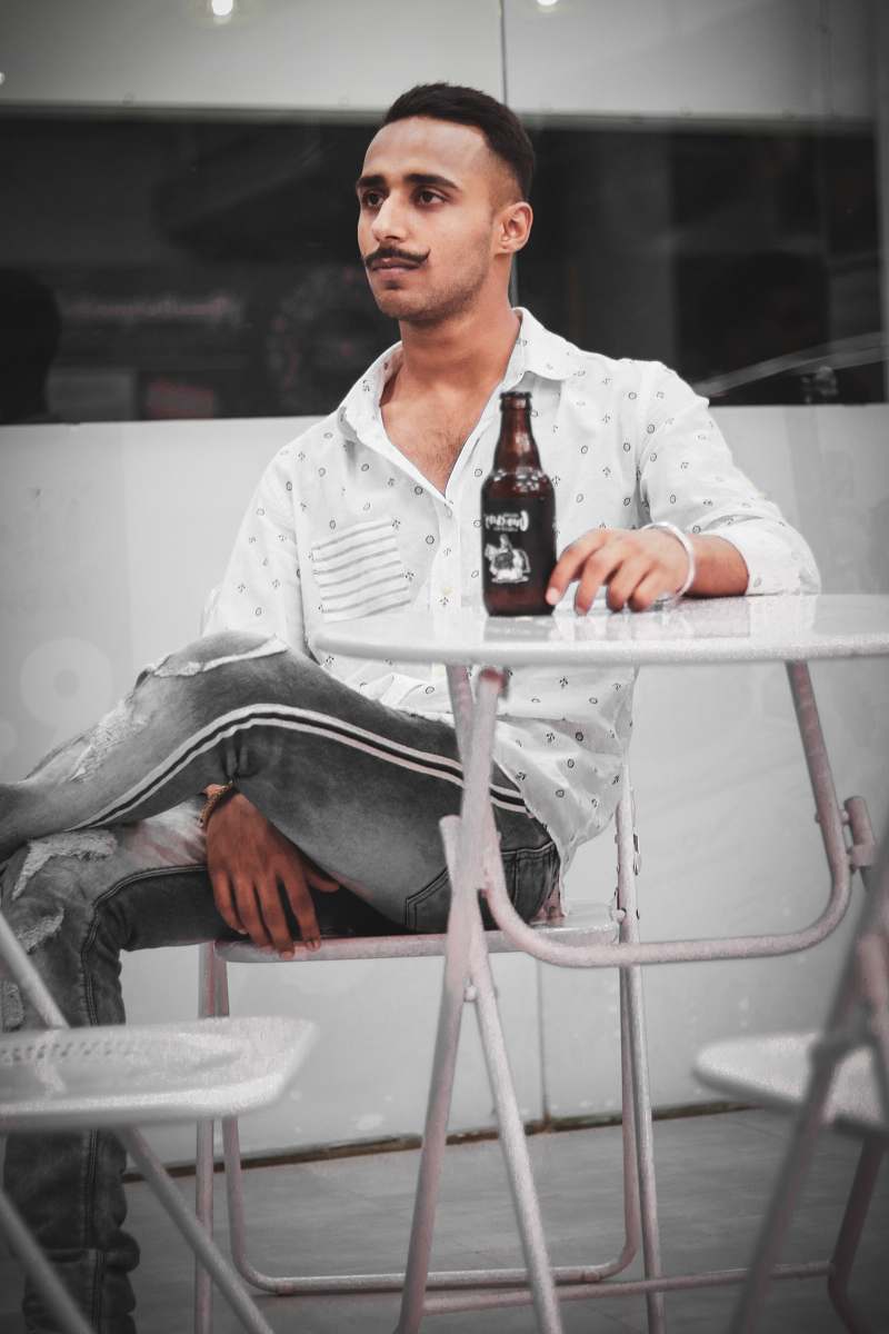 person man sitting on white chair sitting