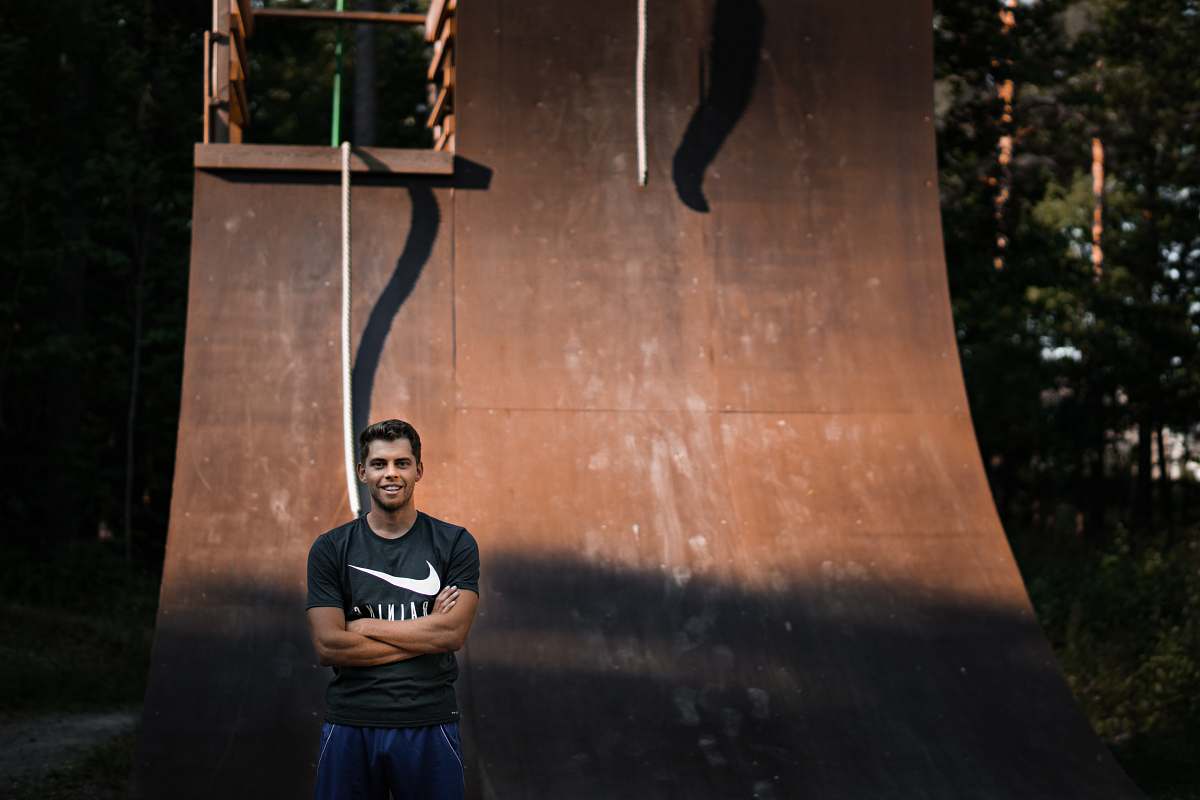 person man standing behind brown wall people