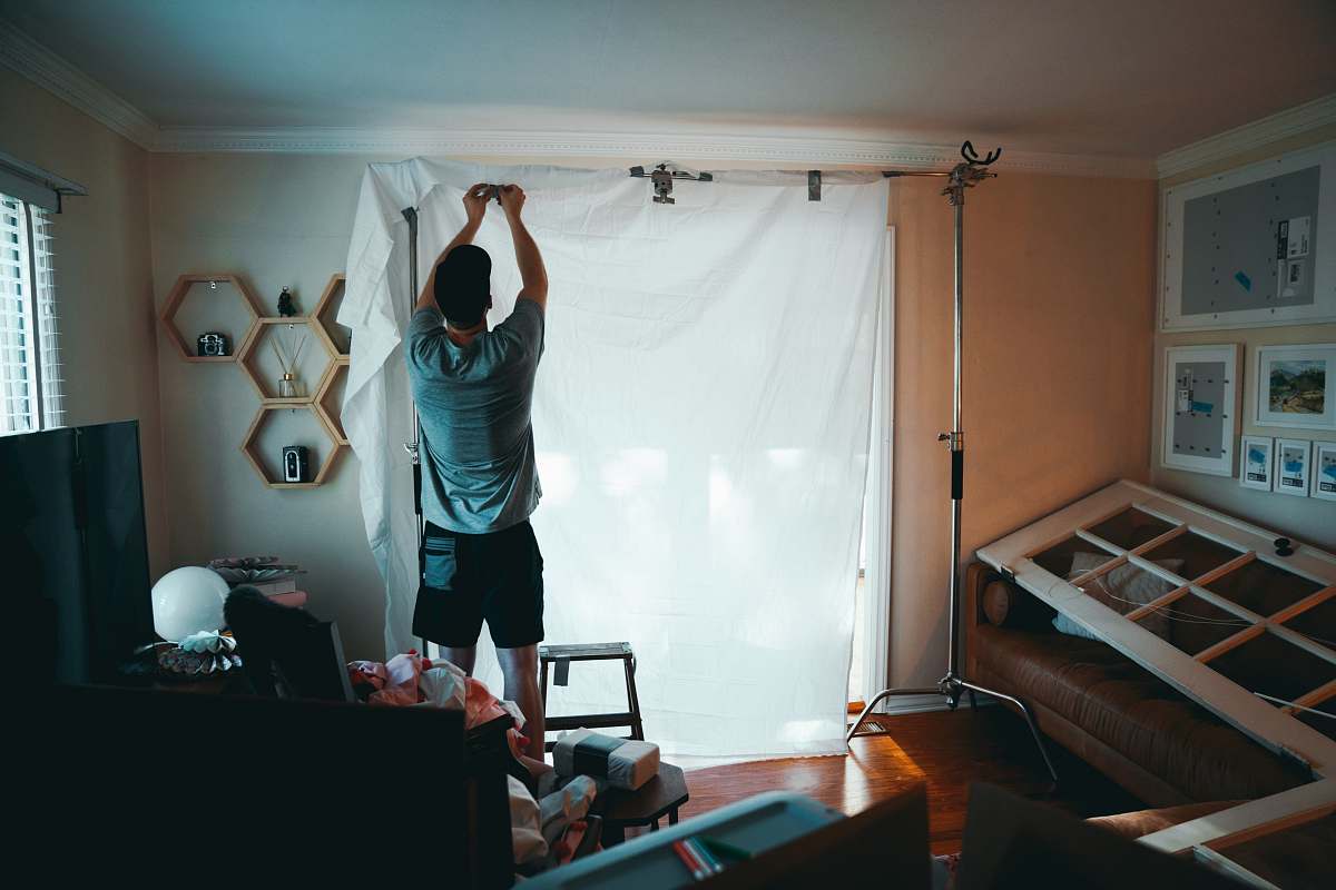 person man standing beside white curtain exercise