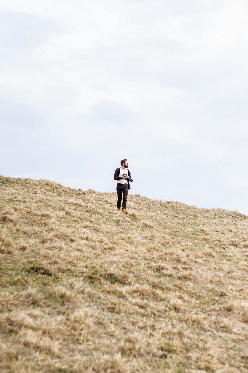 person man standing in open field field