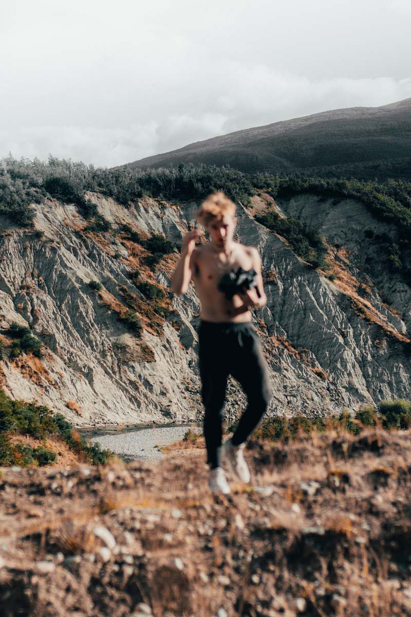 person man standing near mountain range outdoors