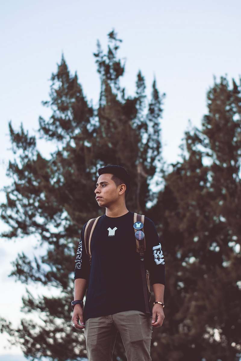 person man standing near tree apparel