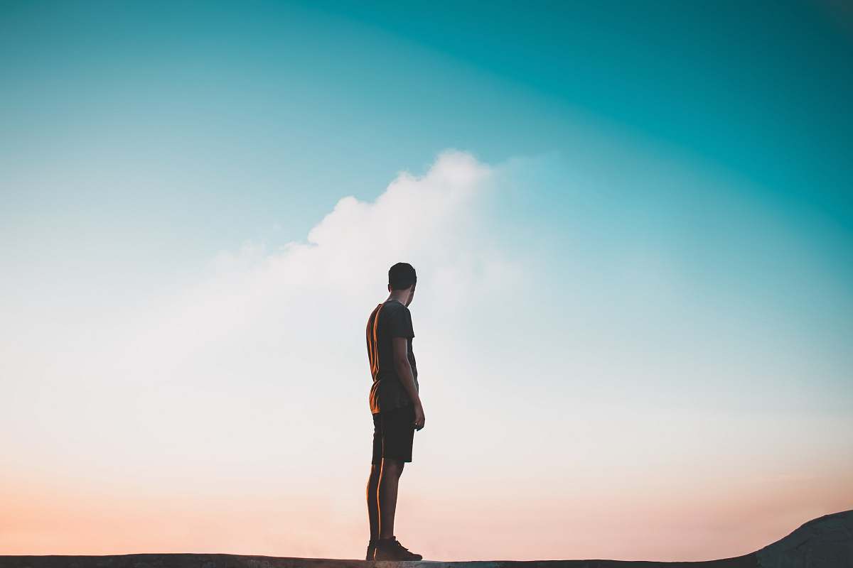 person man standing on flat surface during daytime people