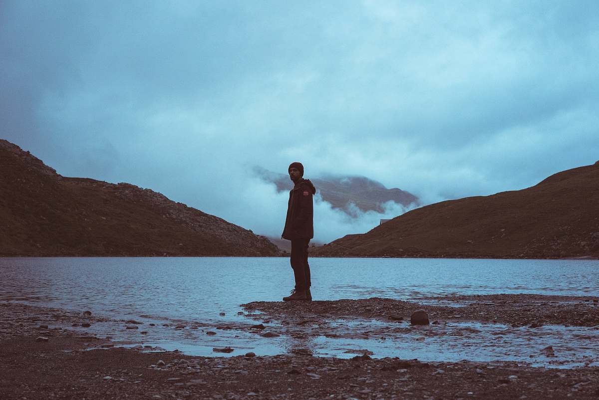 person man standing on shoreline people