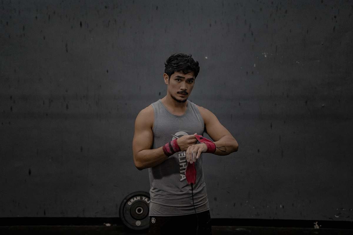 person man standing wearing gray tank top sports
