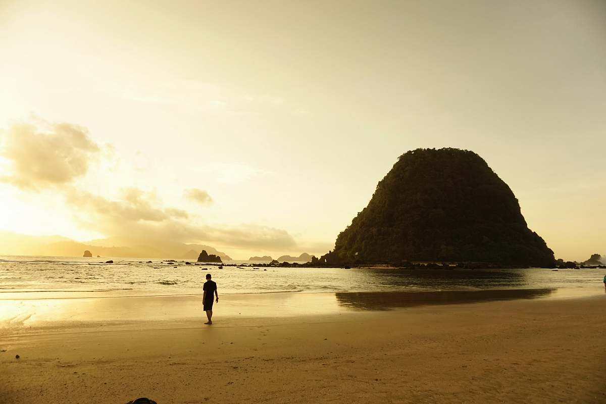 person man walking near shores shoreline