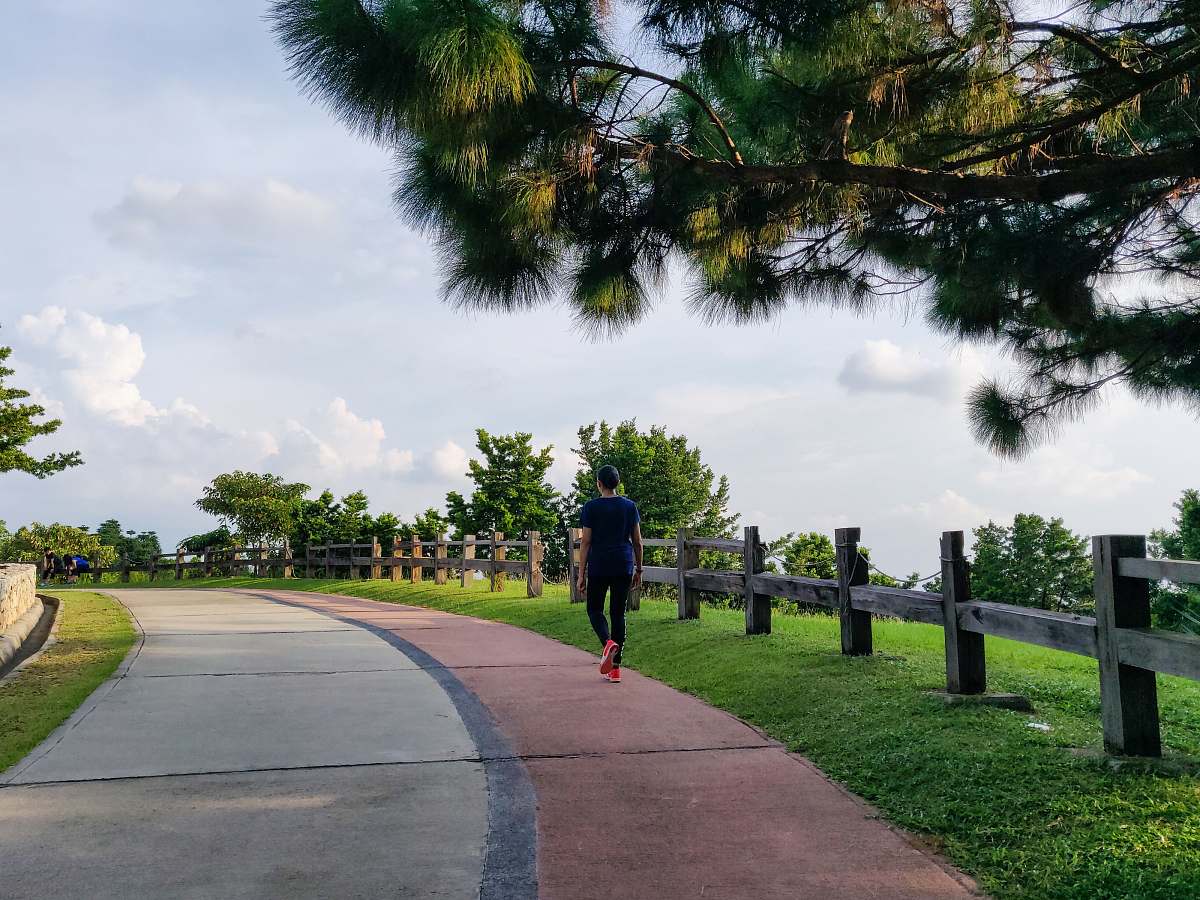 person man walking under white clouds during daytime exercise