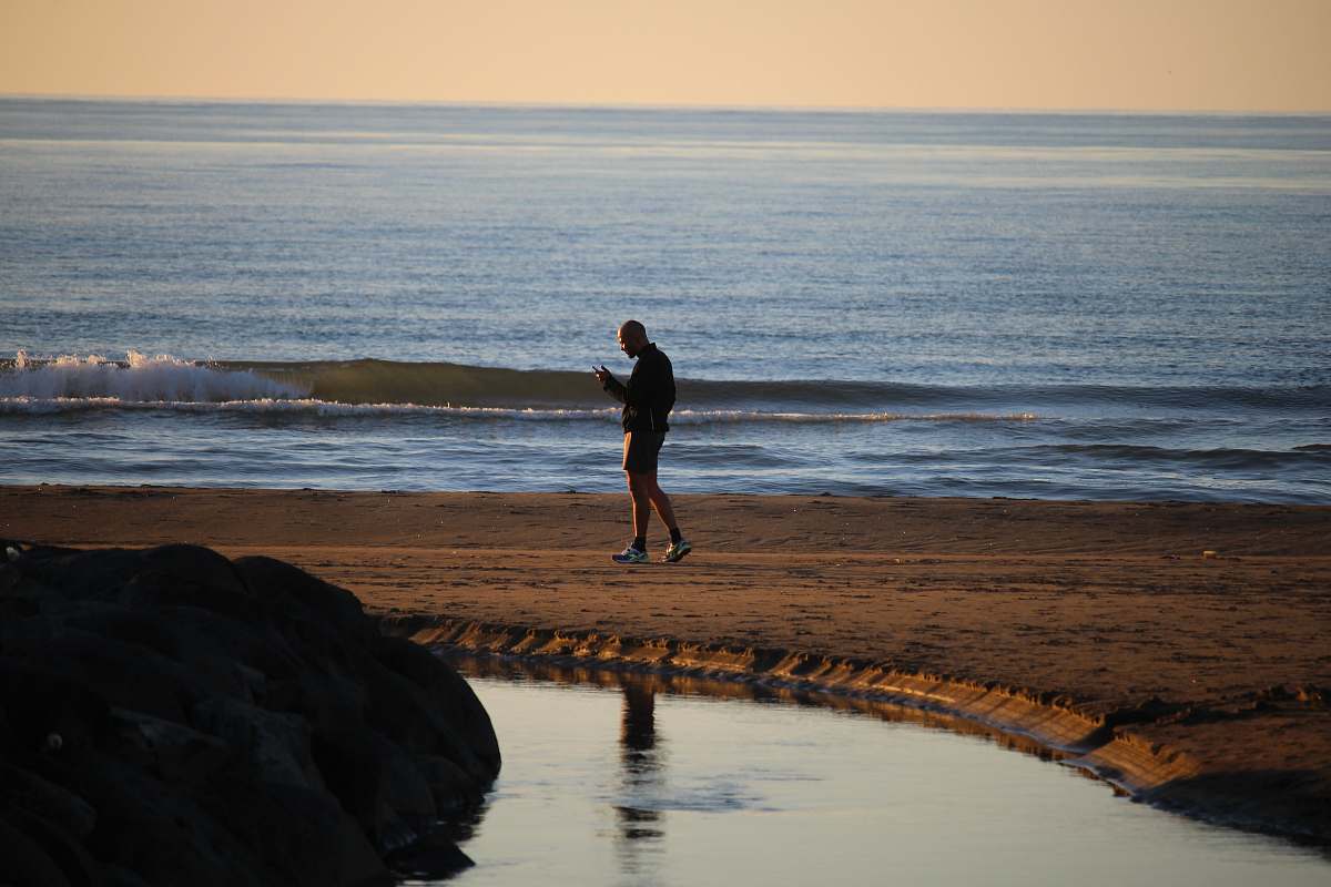 person man wearing short standing on shore nature