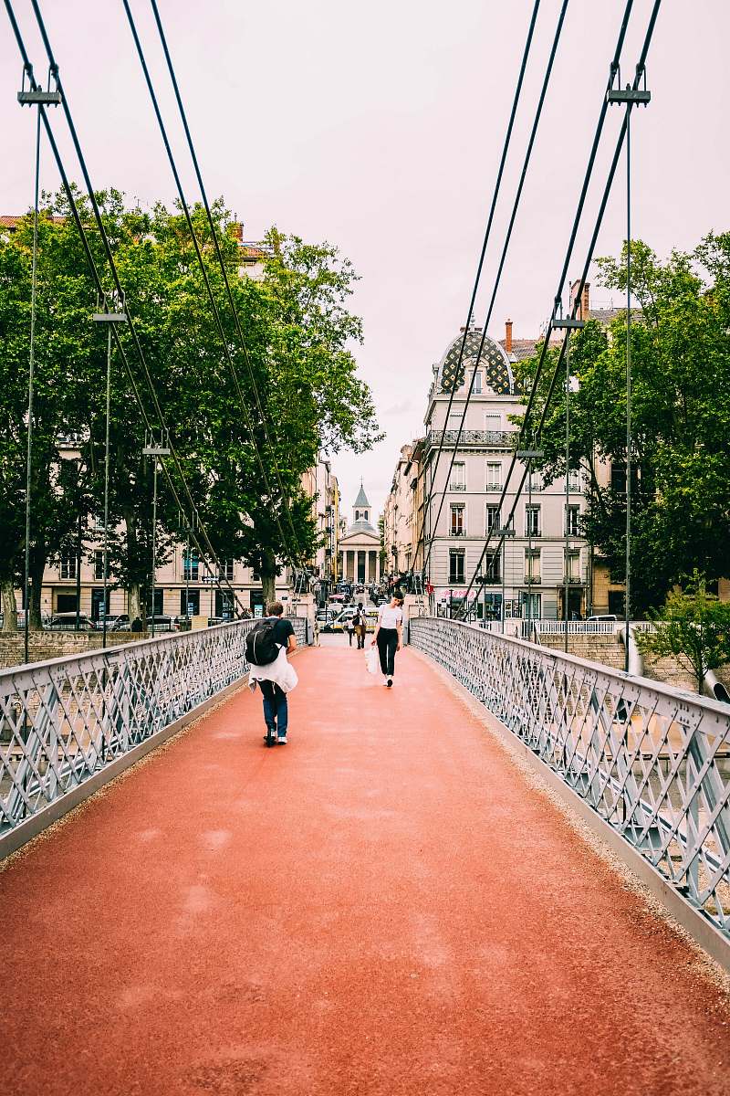 person people walking on bridge during daytime railing