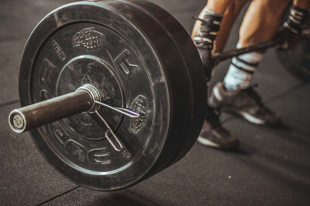 person person holding barbell people