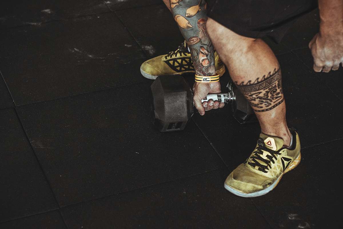 person person lifting black barbell people