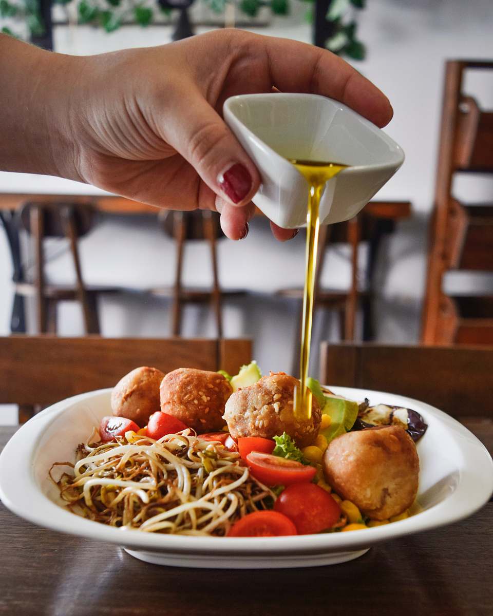 person person pouring honey on cooked food food