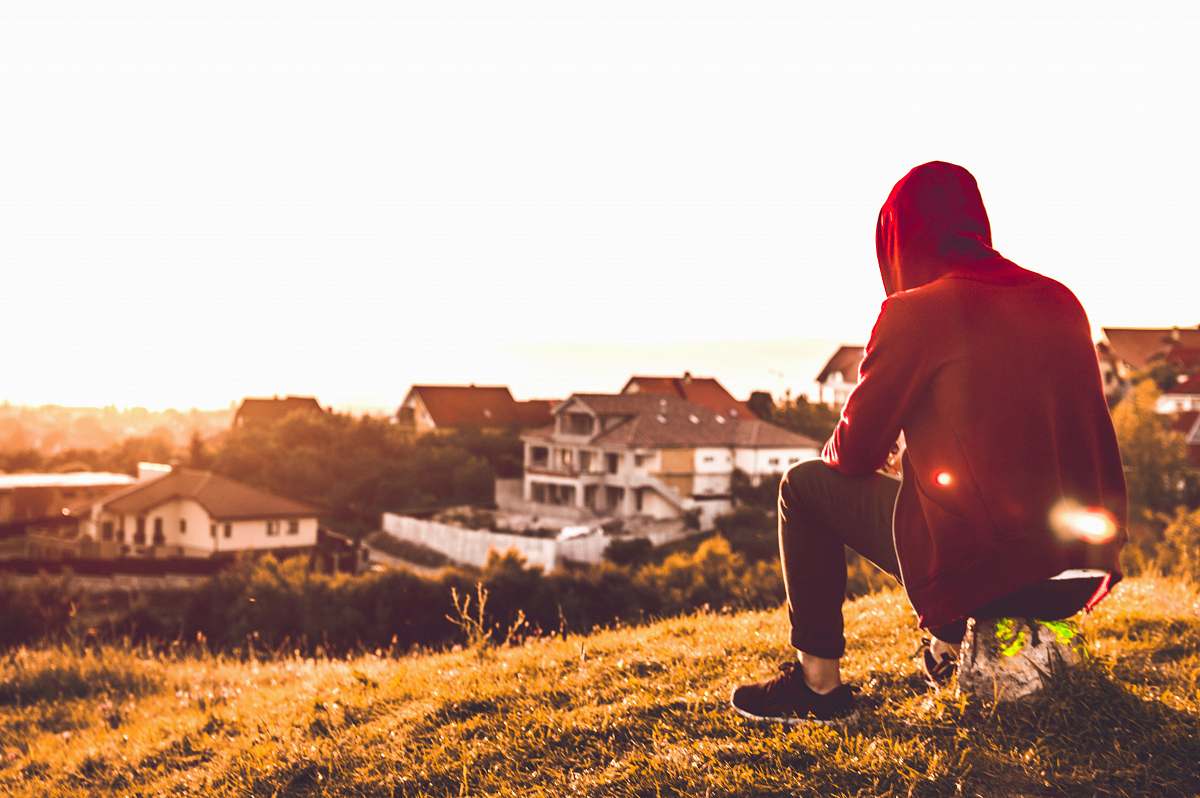 person person sitting in hill near houses during daytime romania
