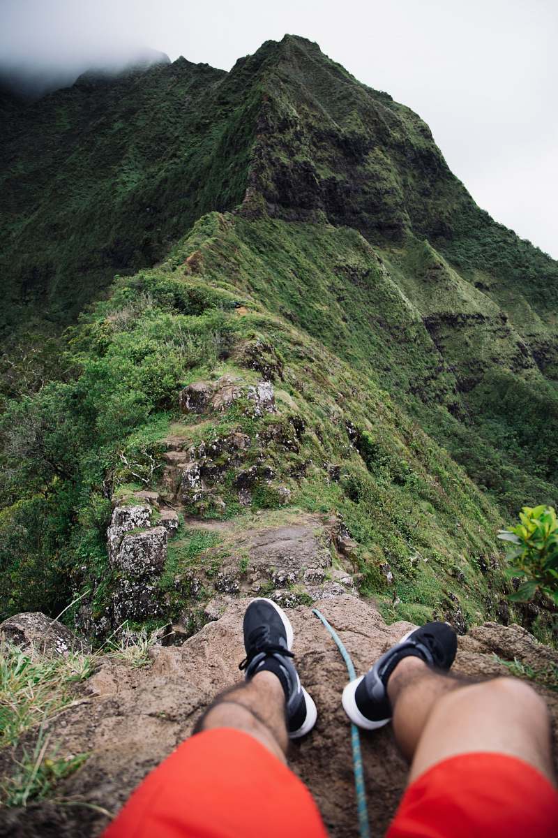 clothing person sitting on mountain cliff apparel