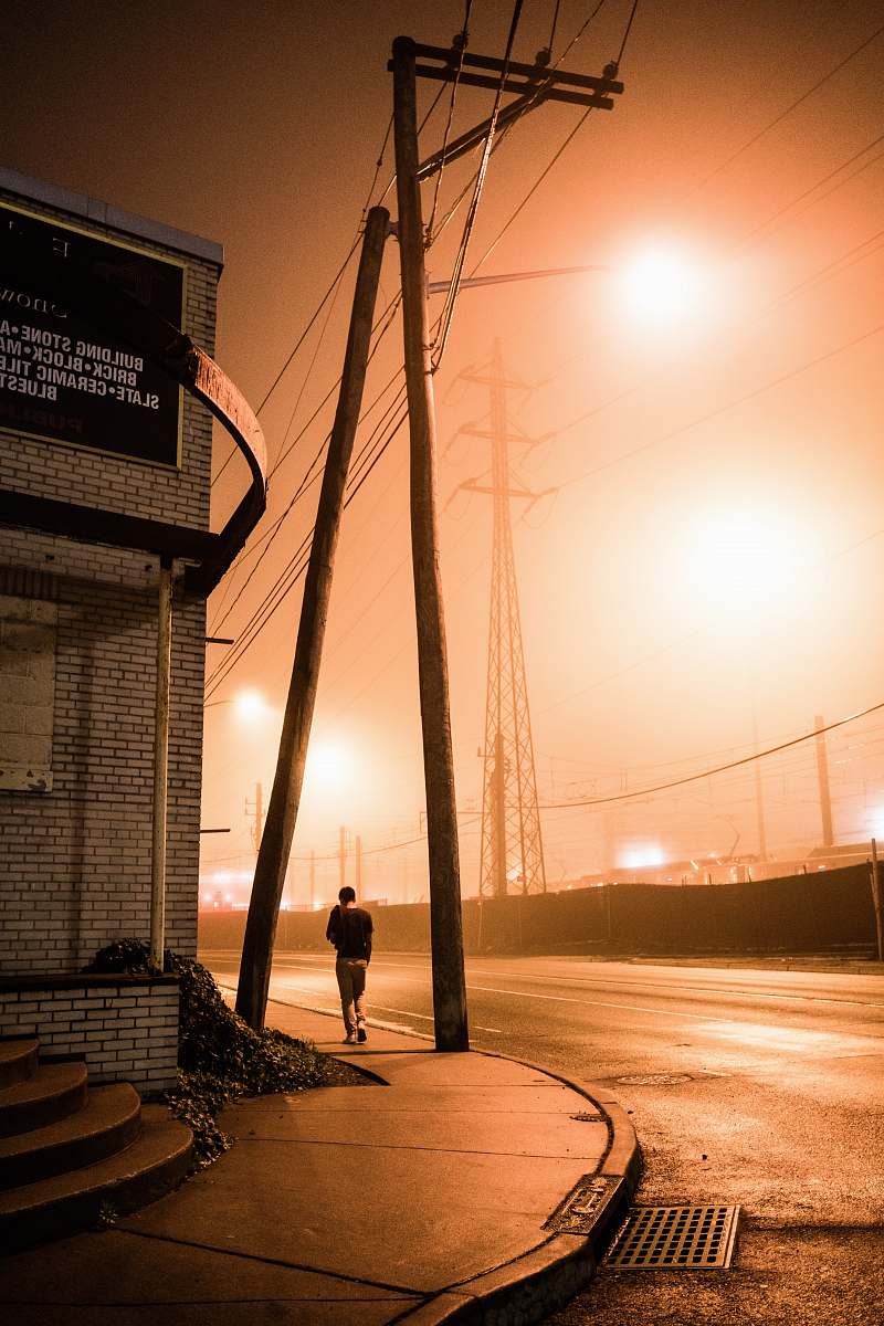 person person walking beside road flare