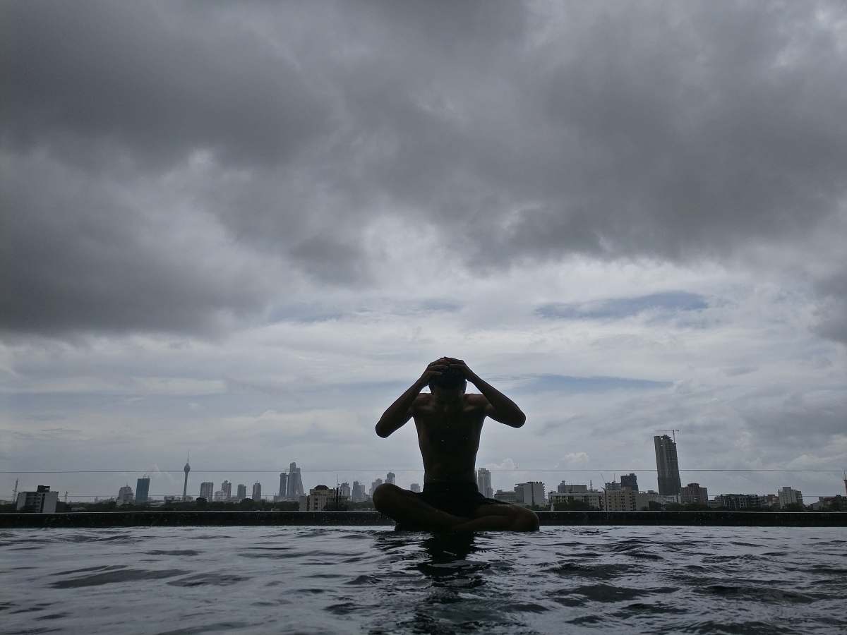 grey photography of man on body of water under cloudy sky during daytime water