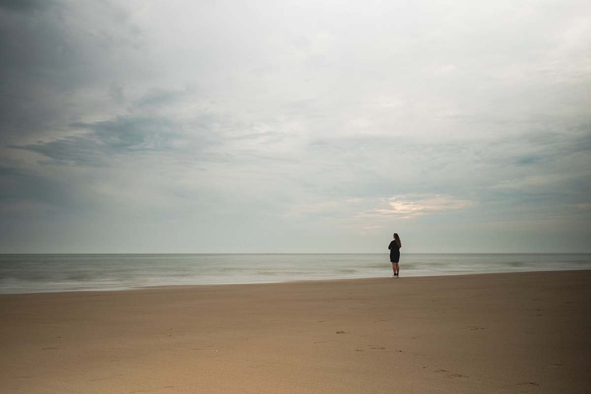 person rule of thirds photography unknown person standing near body of water nature