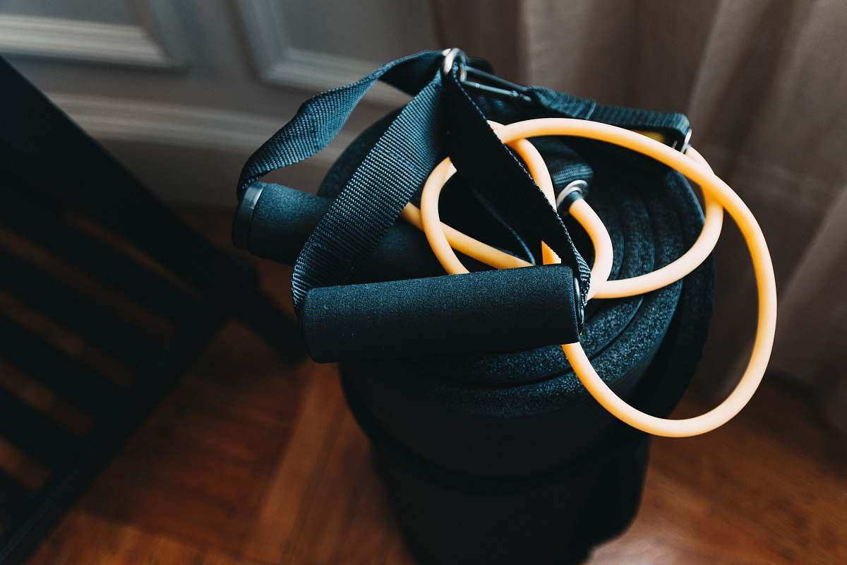 person shallow focus photography of yellow and black stretch rope people