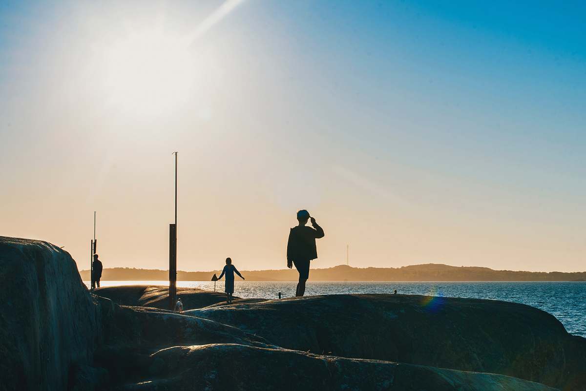 person silhouette of person standing by the sea during daytime outdoors