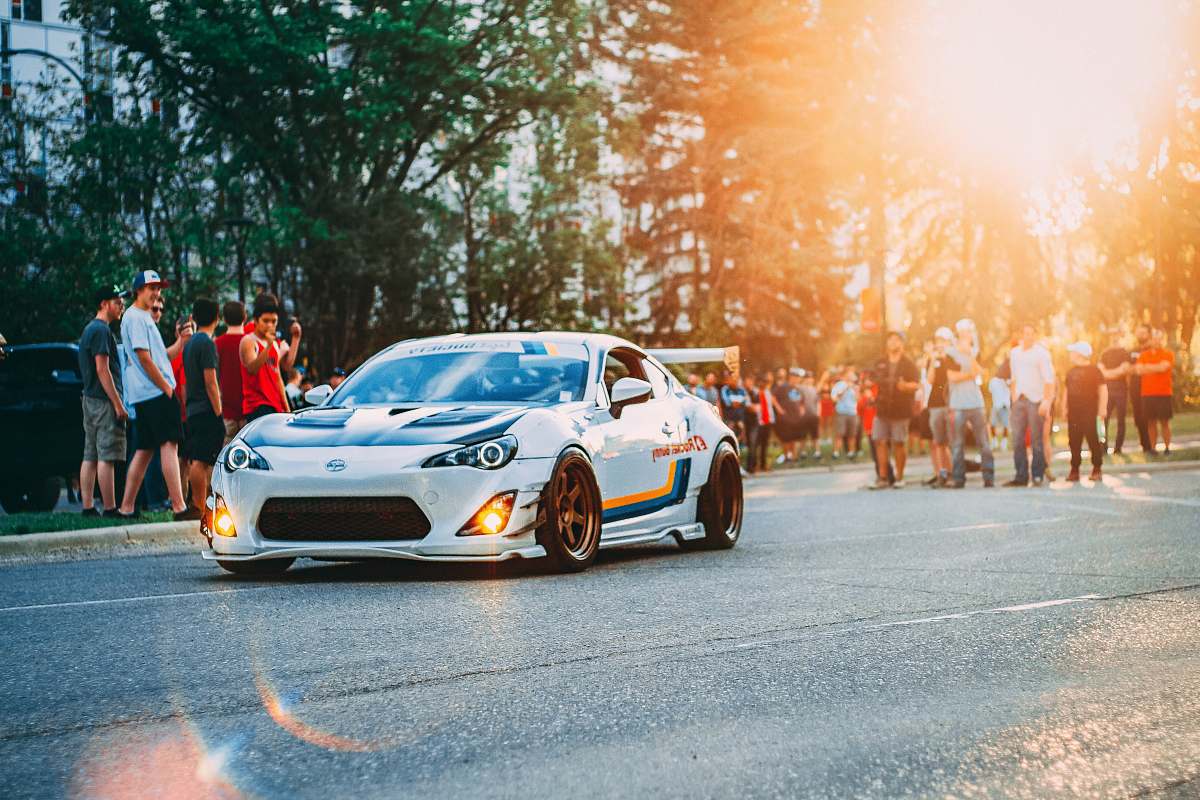 person sports car passe group of people people
