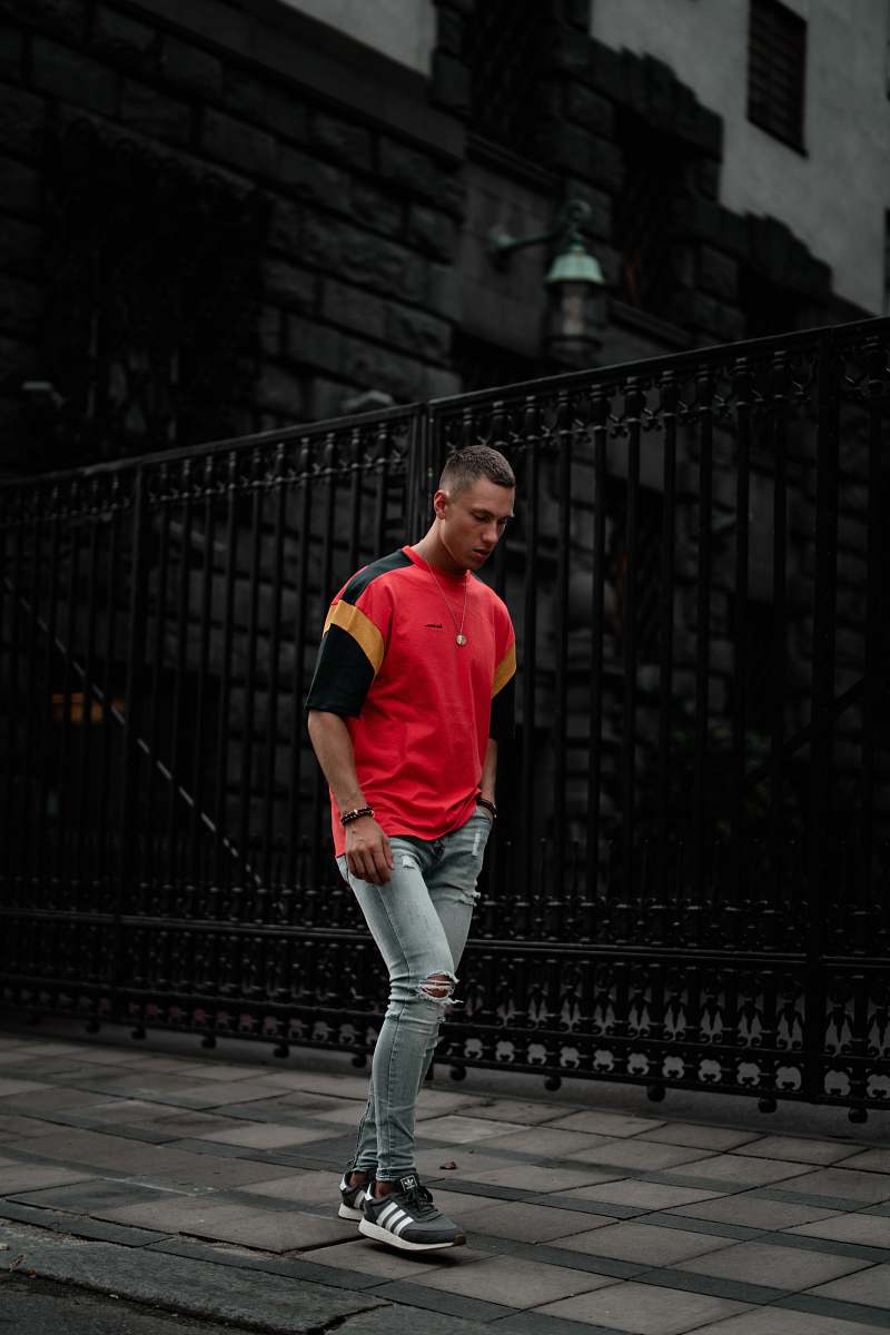people standing man wearing red and black t-shirt person