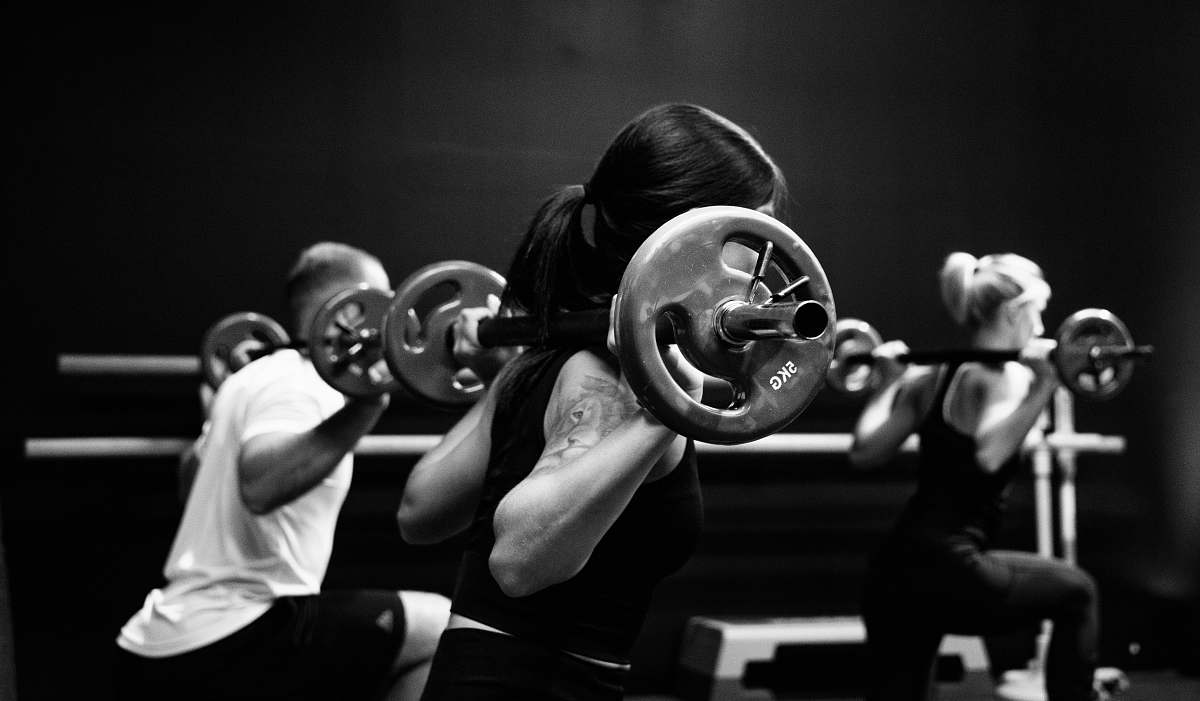 black-and-white three person lifting barbels sport