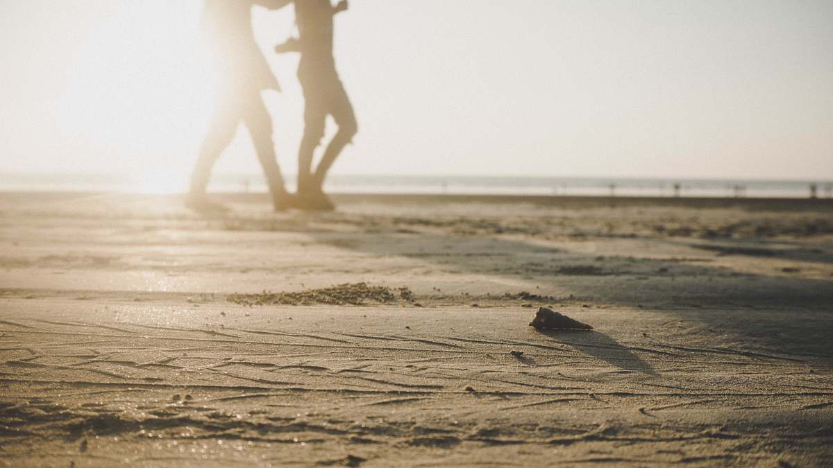 person two person walking on sand during daytime exercise
