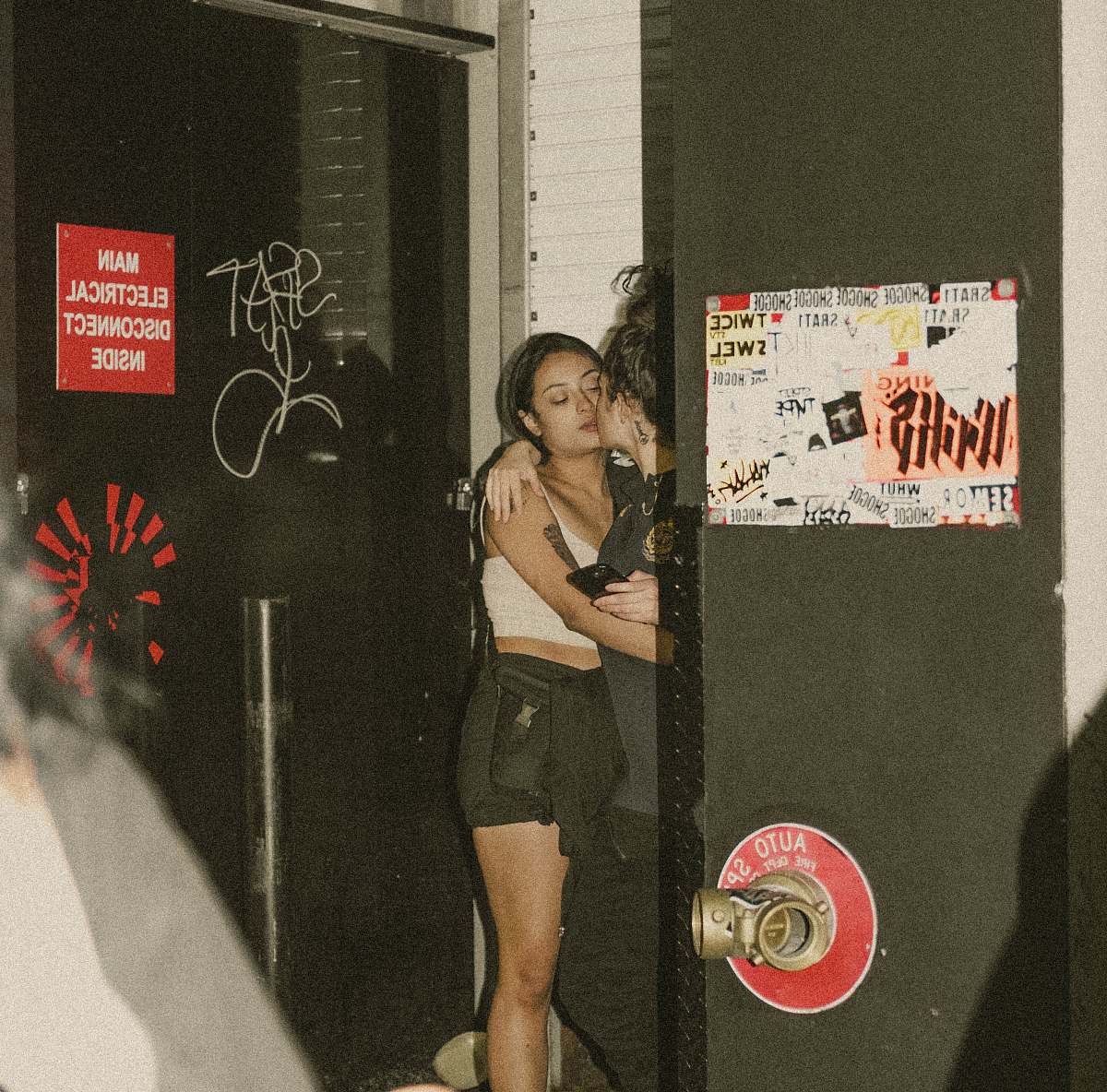 person two women kissing on corner apparel