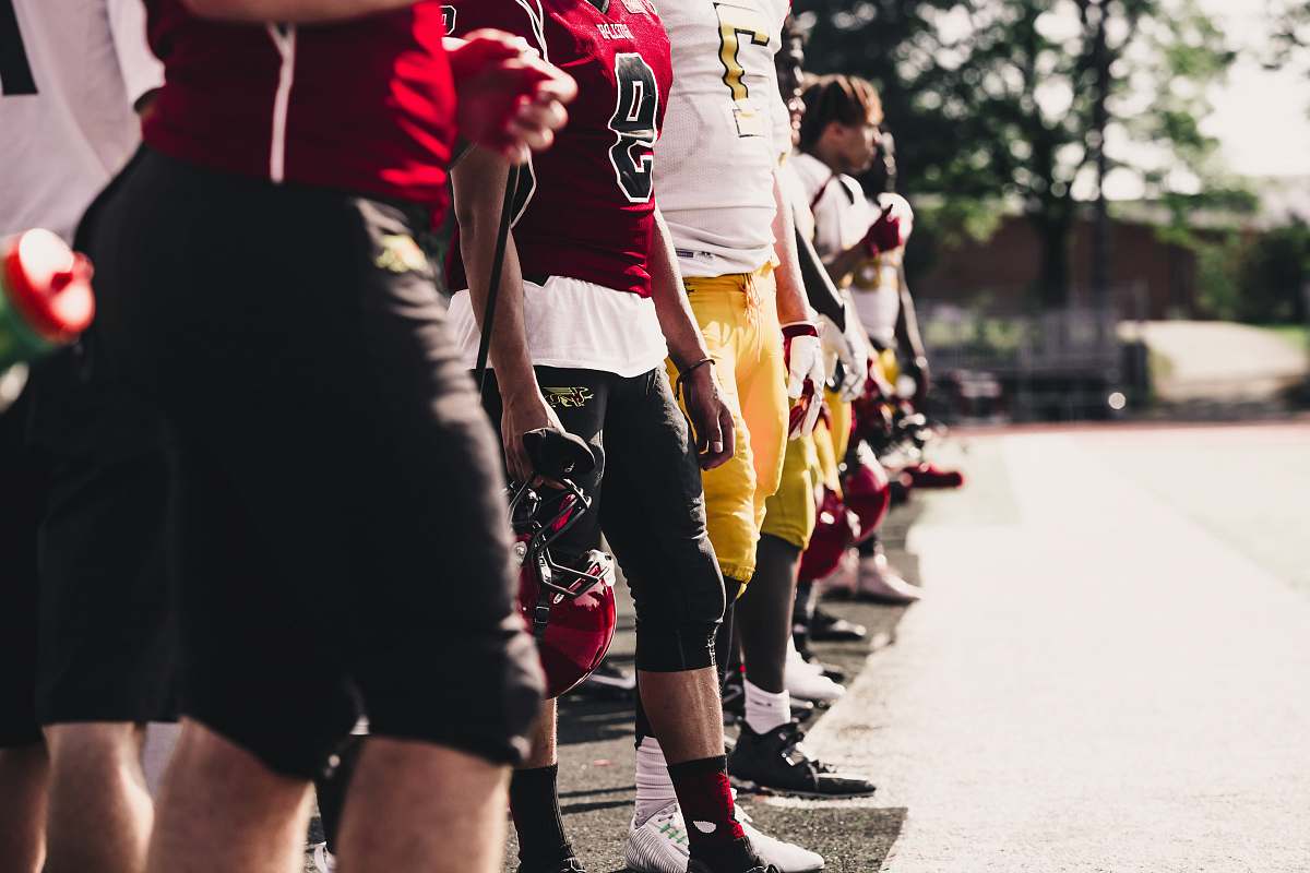 person two yellow-and-red football jerseys people