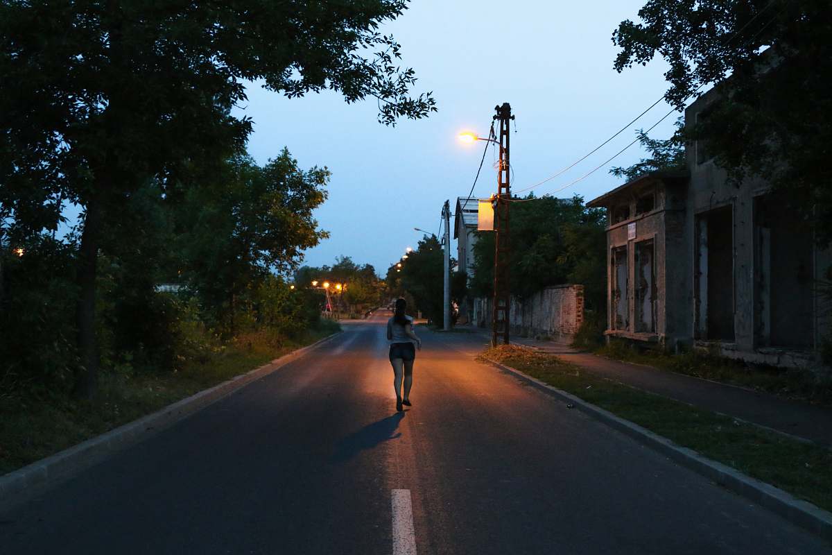 person unknown person running on road asphalt