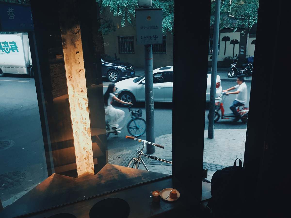 person woman biking near store machine