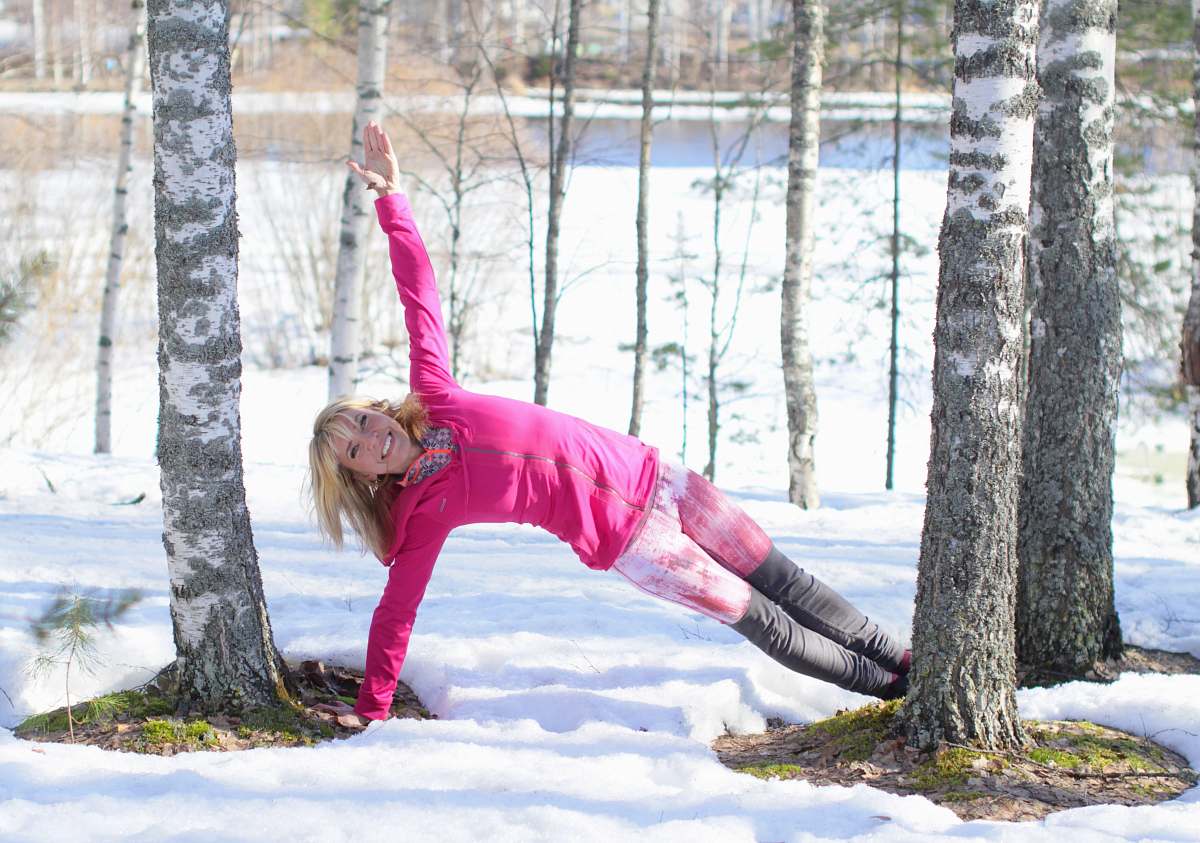 tree woman doing exercise outdoor in beside trees tree trunk