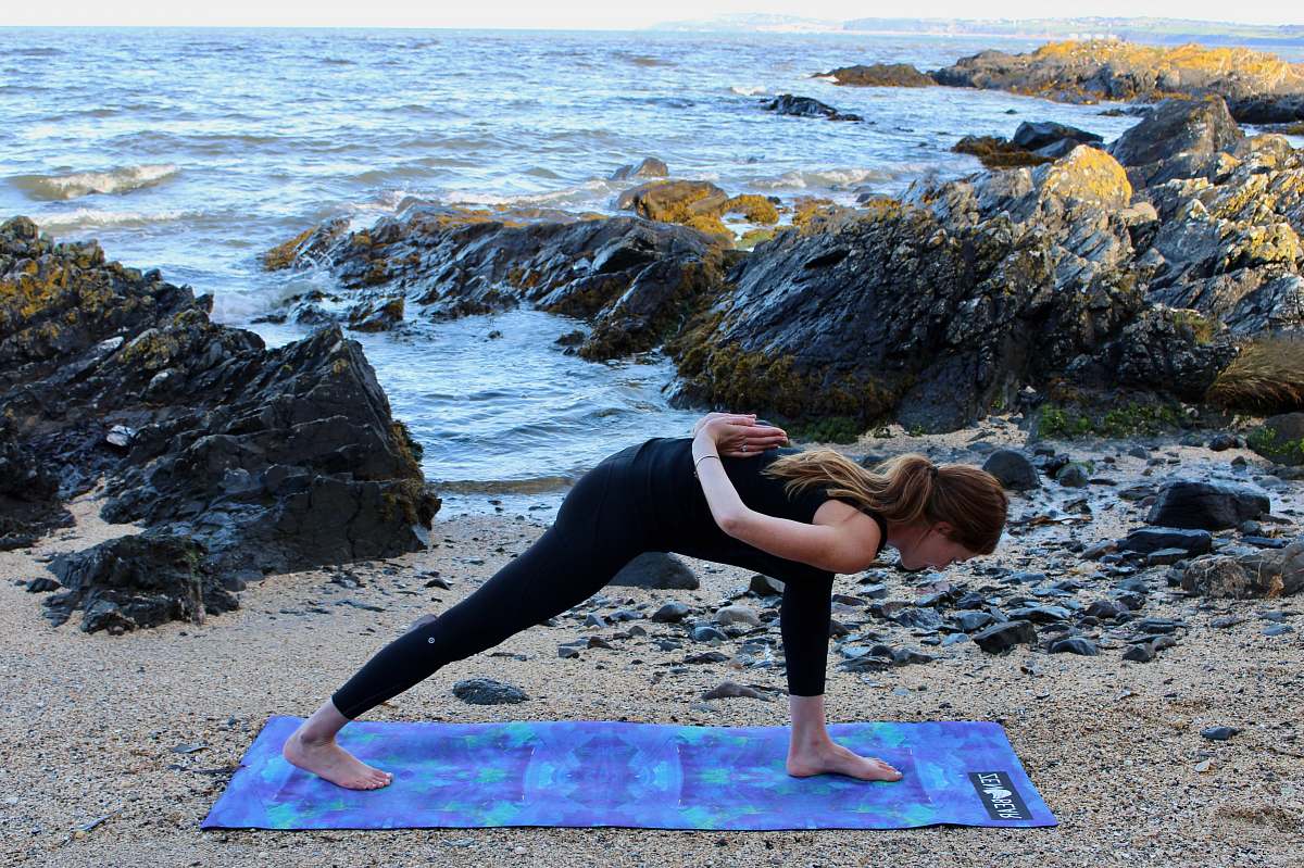 person woman doing yoga at beach sports