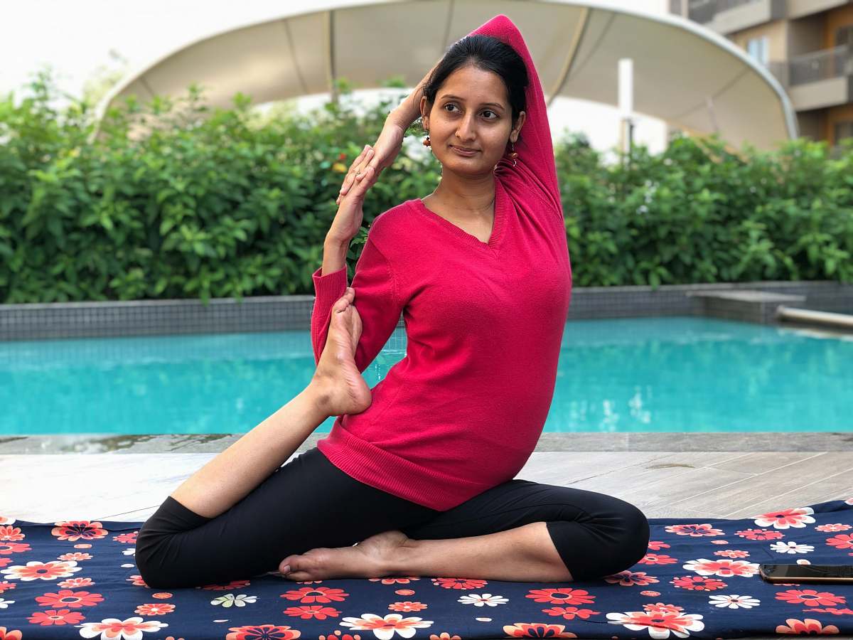 person woman doing yoga near pool exercise