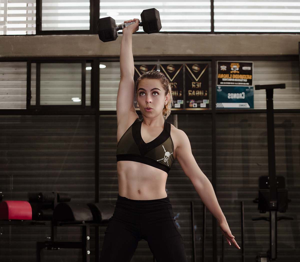 person woman exercising with dumbbell inside gym sport