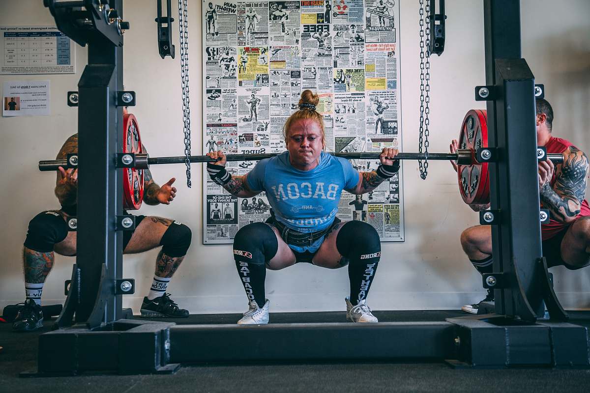 person woman holding barbell people