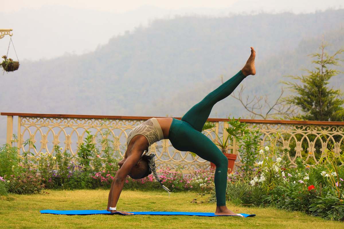 person woman in teal leggings posing yoga exercise