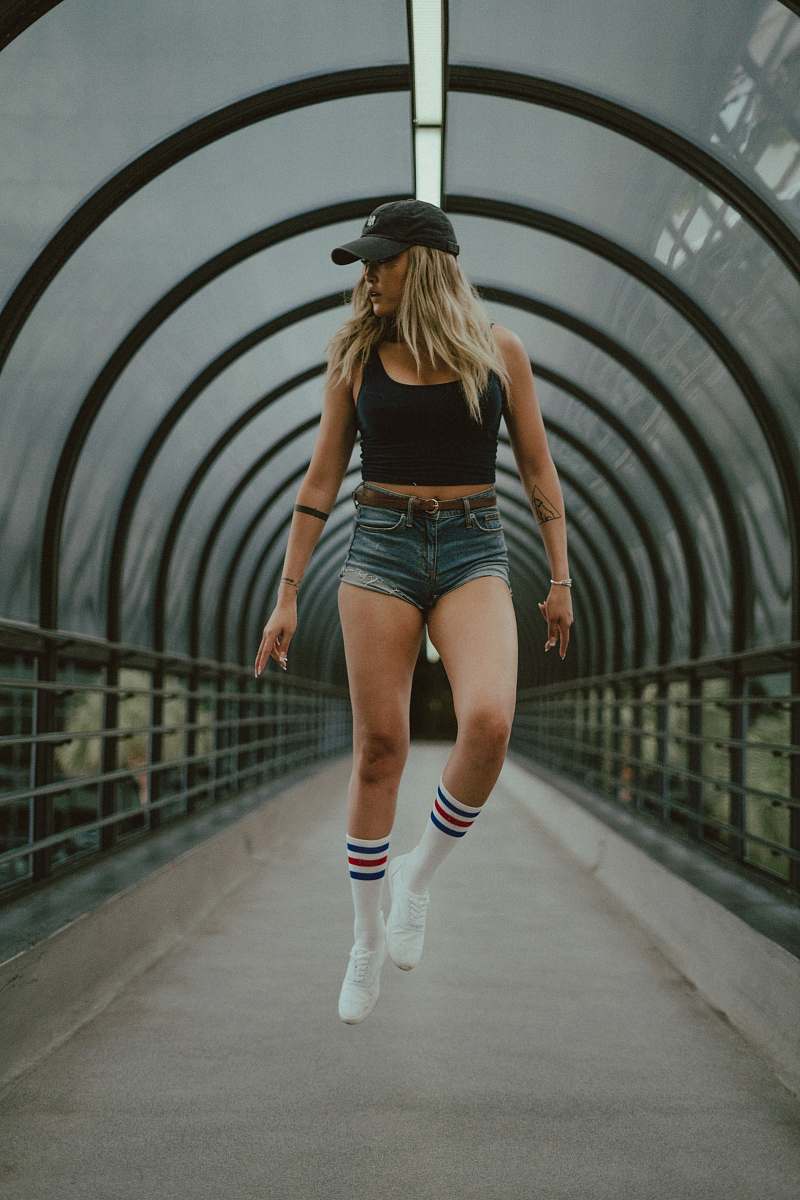 person woman inside concrete walkway with black canopy during daytime people