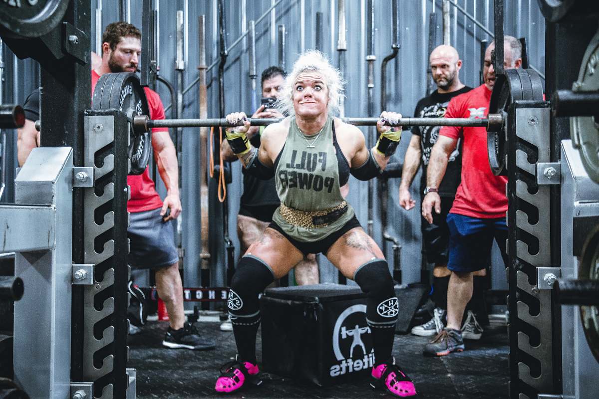 person woman lifting barbell people