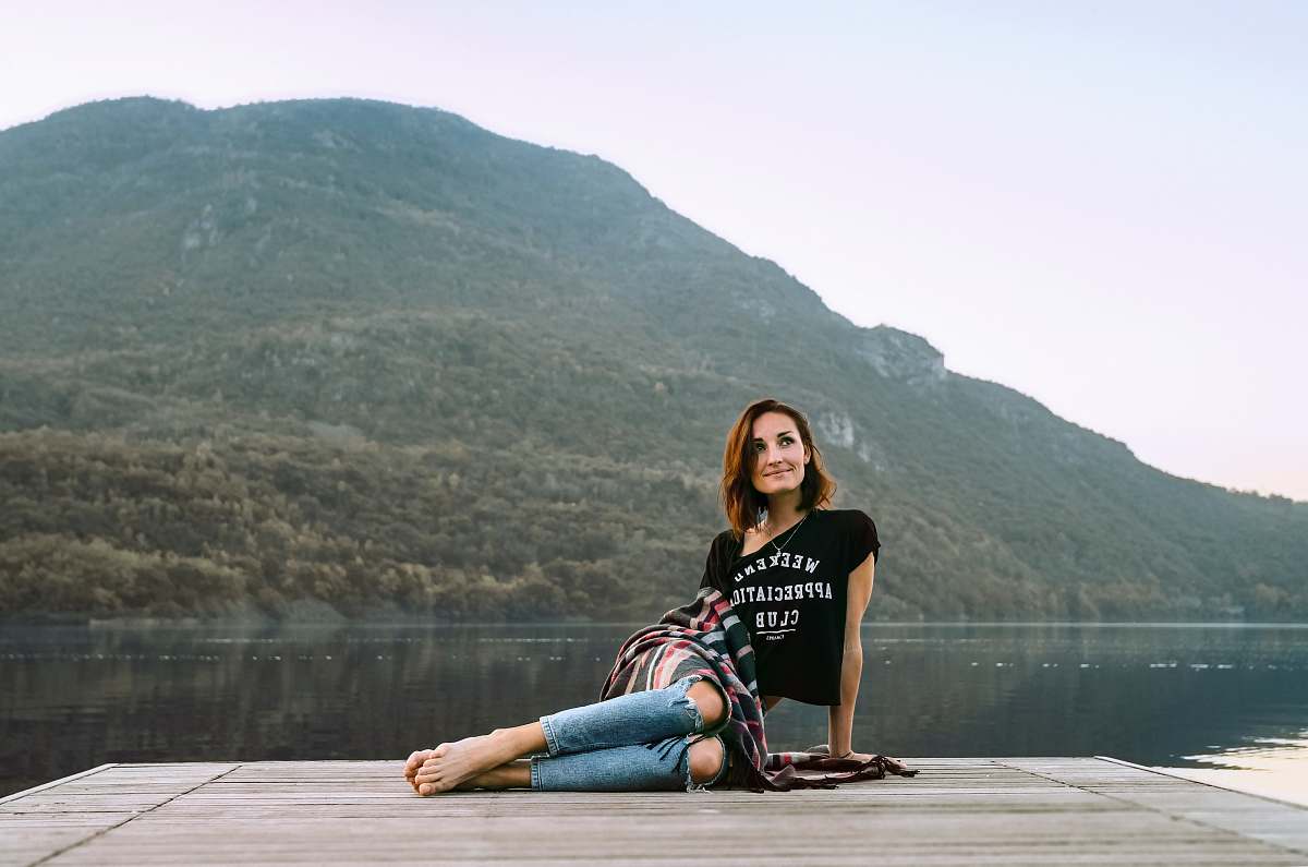 people woman posing on dock located across the mountain person