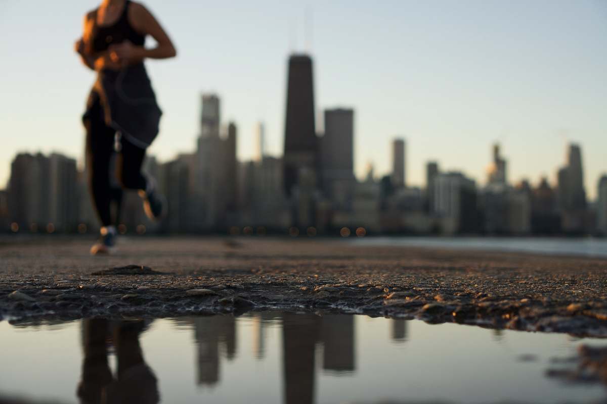 person woman running near body of water puddle